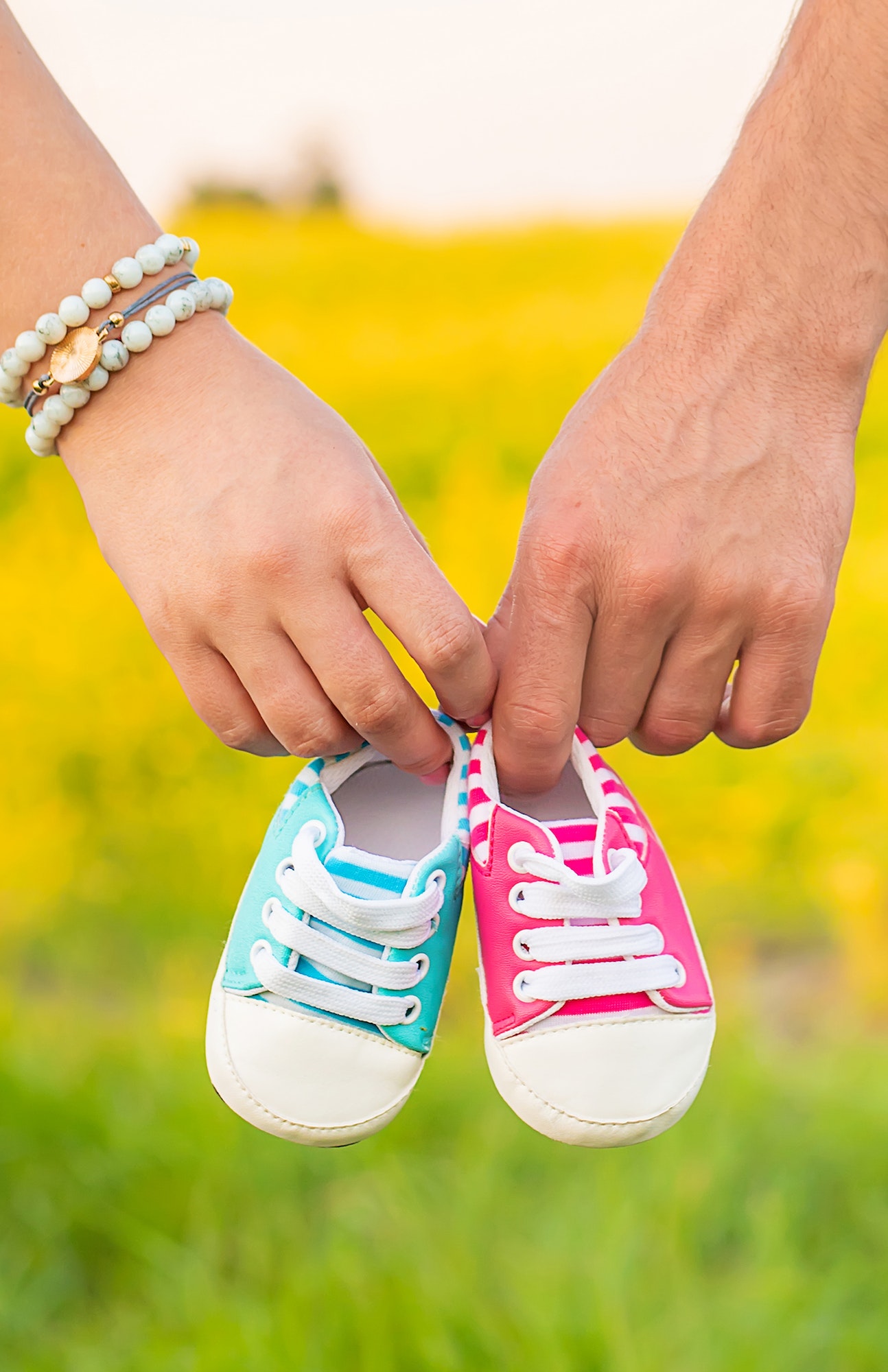 pregnant-woman-and-man-hold-baby-shoes-selective-focus-.jpg